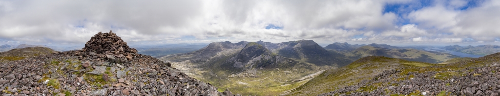 360-Grad-Panorama am Gipfel des Meall a Ghiubhais (887m) mit Blick auf den langen Kamm des Beinn Eighe Massivs mit seinen einzelnen Gipfeln, den wuchtigen sich davor erhebenden Ruadh-Stac Beag (896m), den weiter entfernten Kamm des Liathach mit der höchsten Gipfelerhebung des Spidean a Choire Leith (1055m), das Hochplateau des Beinn a Chearcaill (725m) mit dem dahinter aufragenden Beinn an Eoin (855m) sowie den langgestreckten Loch Maree, Torridon Mountains, Schottland, Juni 2024.