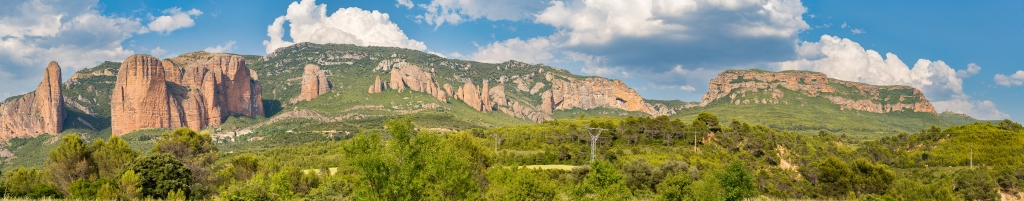 Panoramablick auf die beeindruckenden roten Konglomerat-Felsformationen der Mallos de Riglos oberhalb des Bergdorfes von Las Penas de Riglos in Aragonien, Nordspanien, Mai 2025.